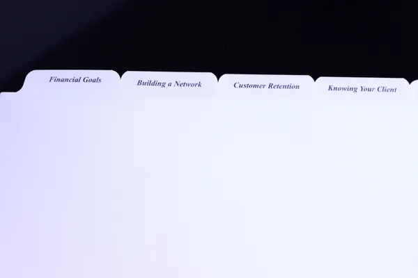 Custom printed advisor binder tabs reading Financial Goals, Building a Network, Customer Retention and Knowing Your Client