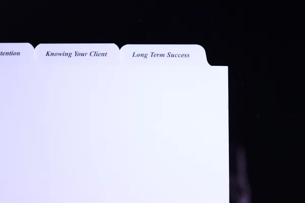 Close view of printed advisor binder tab titles on Mylar reinforced tabs