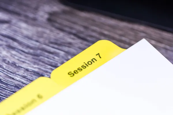 Close-up of a yellow Mylar reinforced tab extension bonded to white index stock