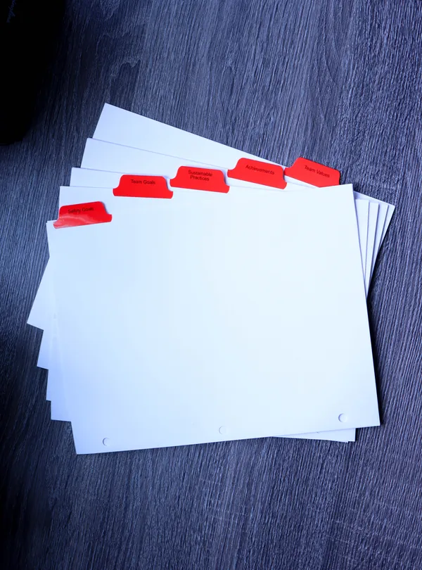 Red Mylar index tab dividers stepped in a collated stack