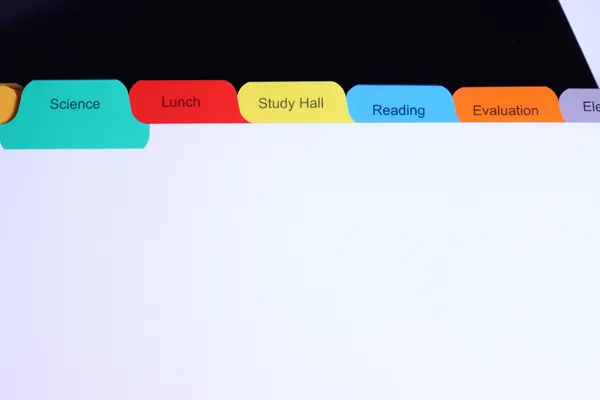 Multicolored school subject index tabs used as a color-coded filing system