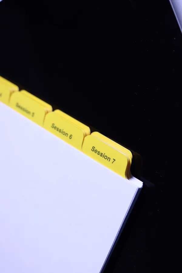 Close view of yellow Mylar index tabs stepped down the side of a divider set