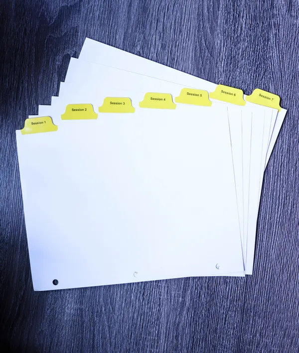 Collated yellow Mylar index tab set stepped across a desk